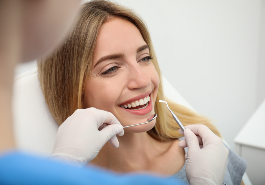 Young woman smiling during dental check-up after teeth whitening